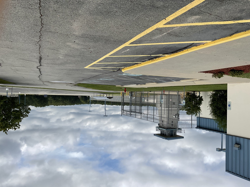 View of the fenced exterior and RCI building with its watchtower in the distance.